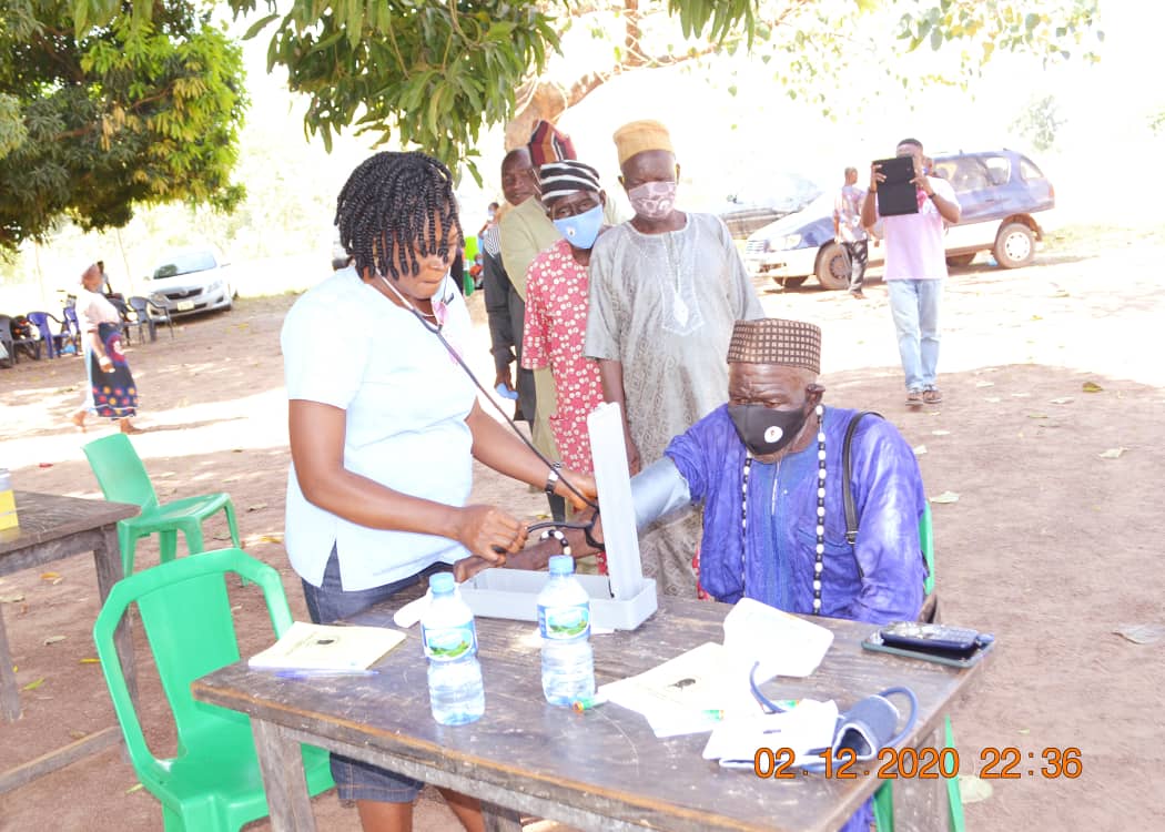 Patient receiving a consultation from a medical volunteer at Atighir Village outreach.